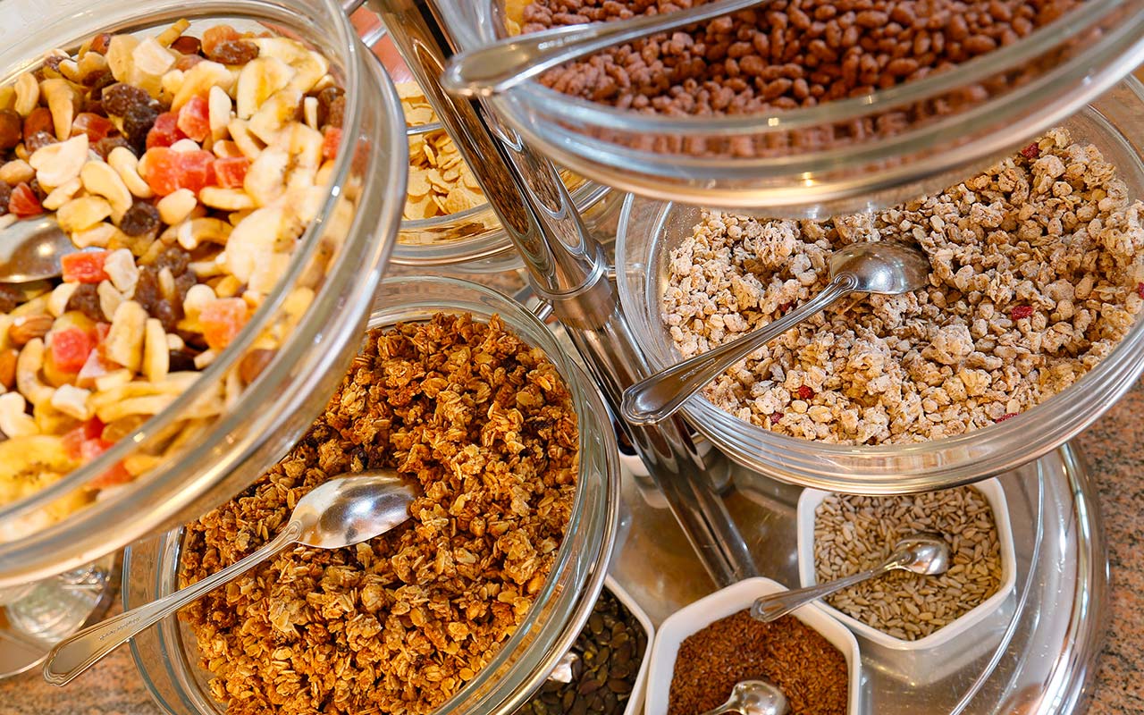 Bowls with different kinds of cereal prepared breakfast at  Hotel Kristall